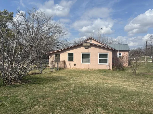 a view of a yard with large trees