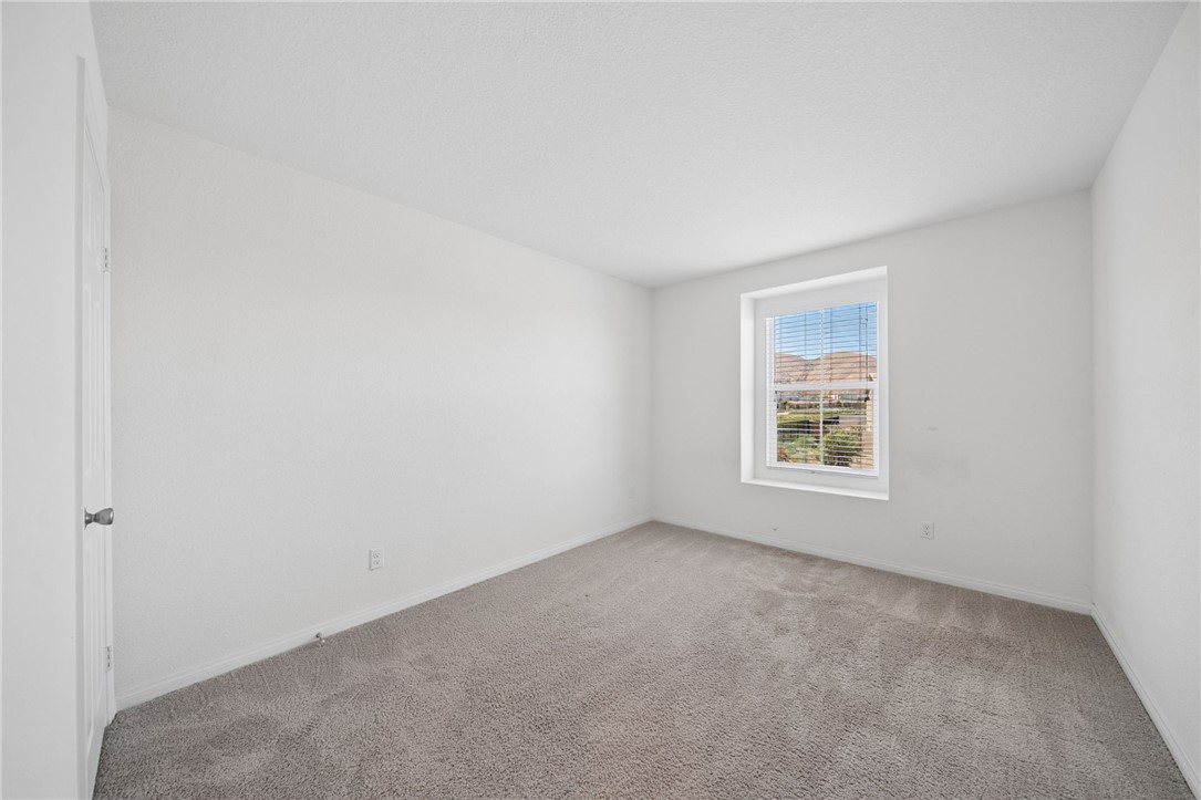 20130 Curaco Court Riverside, CA 92507 - Photo 35 of 43 Carpeted bedroom with a window overlooking the surrounding hills.