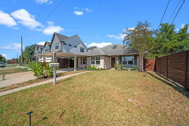 a front view of a house with a garden and porch