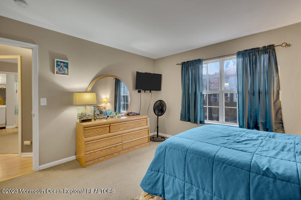 149 Marlin Road Manahawkin, NJ 08050 - Photo 16 of 36 a bedroom with a bed and a large window