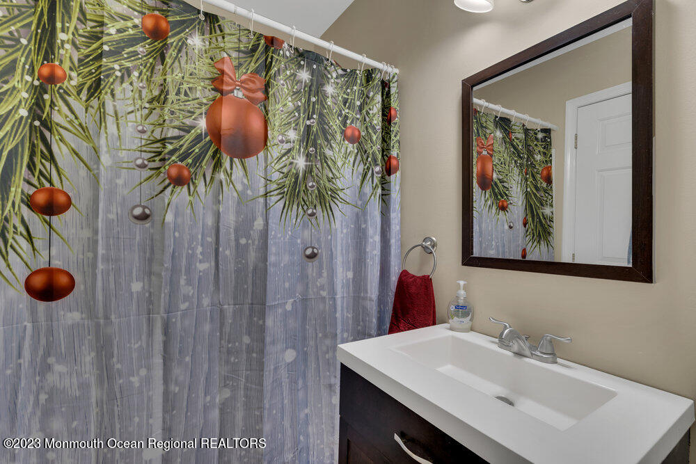 149 Marlin Road Manahawkin, NJ 08050 - Photo 18 of 36 a bathroom with a sink and a mirror