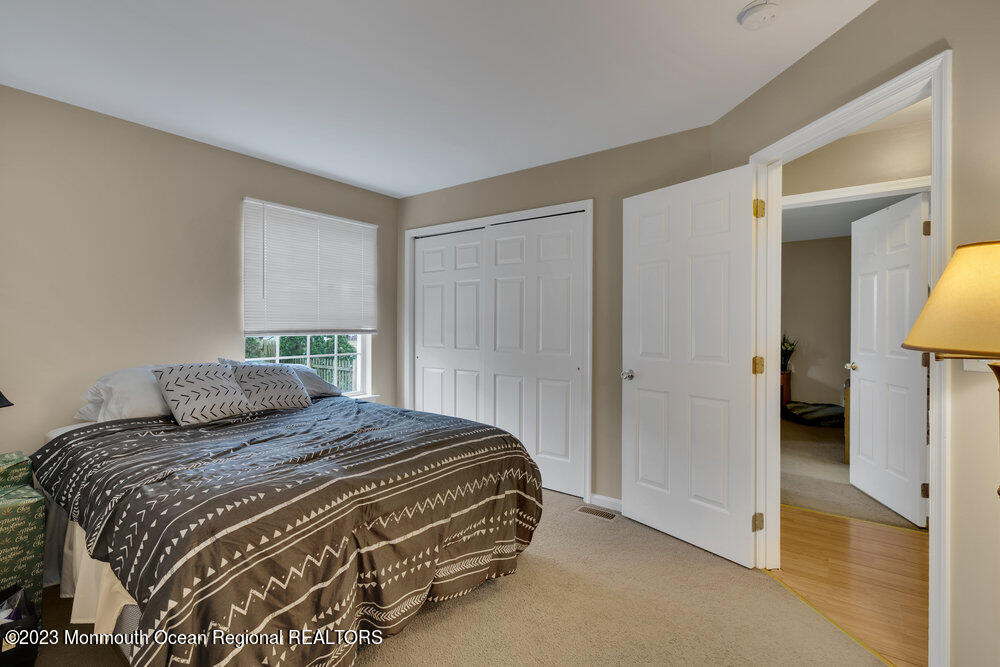 149 Marlin Road Manahawkin, NJ 08050 - Photo 21 of 36 a bedroom with a bed and a mirror