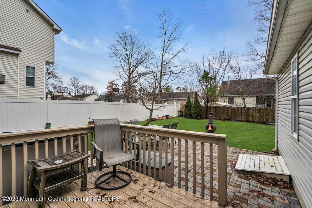149 Marlin Road Manahawkin, NJ 08050 - Photo 29 of 36 a view of a wooden deck and chairs next to a yard