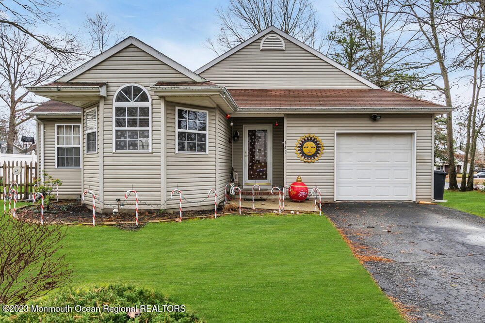 149 Marlin Road Manahawkin, NJ 08050 - Photo 3 of 36 a front view of a house with a yard and garage