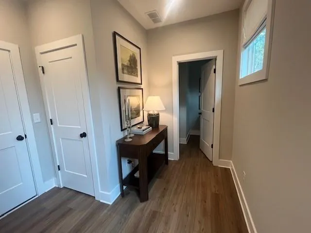 a view of a hallway and a livingroom with furniture