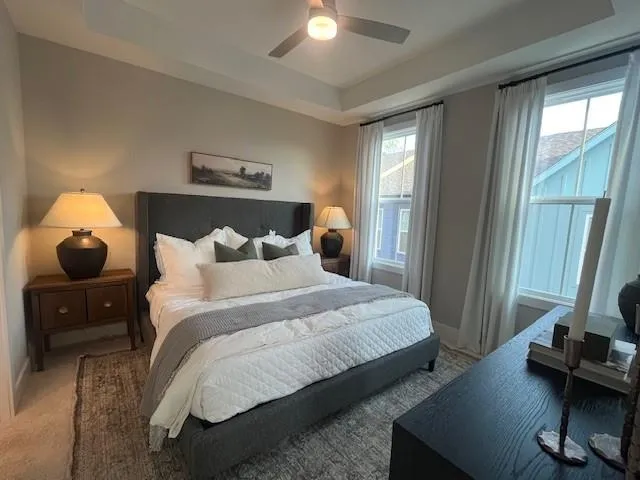 a bedroom with a bed and a mirror next to a window