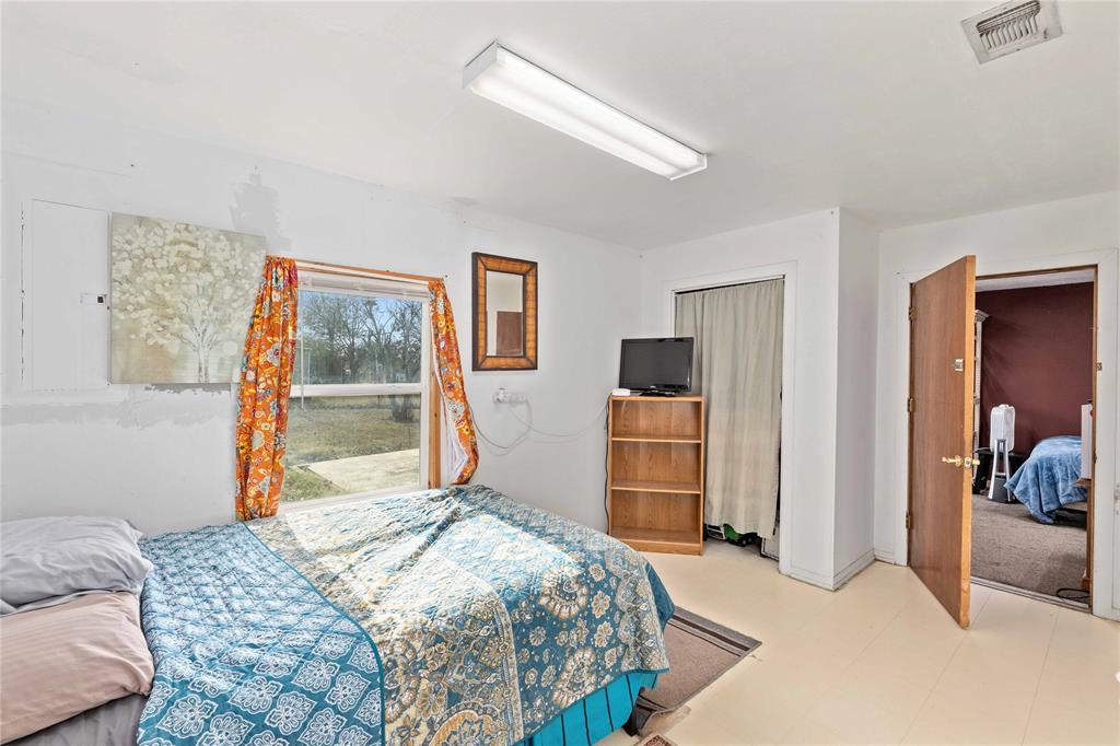 309 Goodwin Street Bangs, TX 76823 - Photo 12 of 20 a bedroom with a bed and a dresser