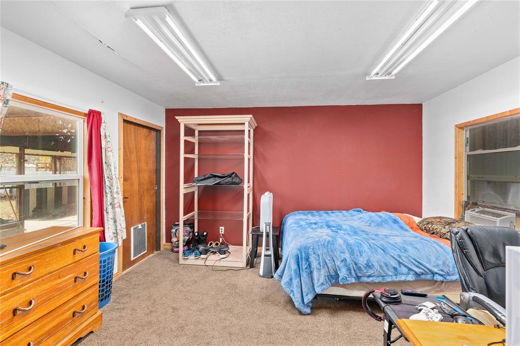 309 Goodwin Street Bangs, TX 76823 - Photo 13 of 20 a bedroom with bed and a window