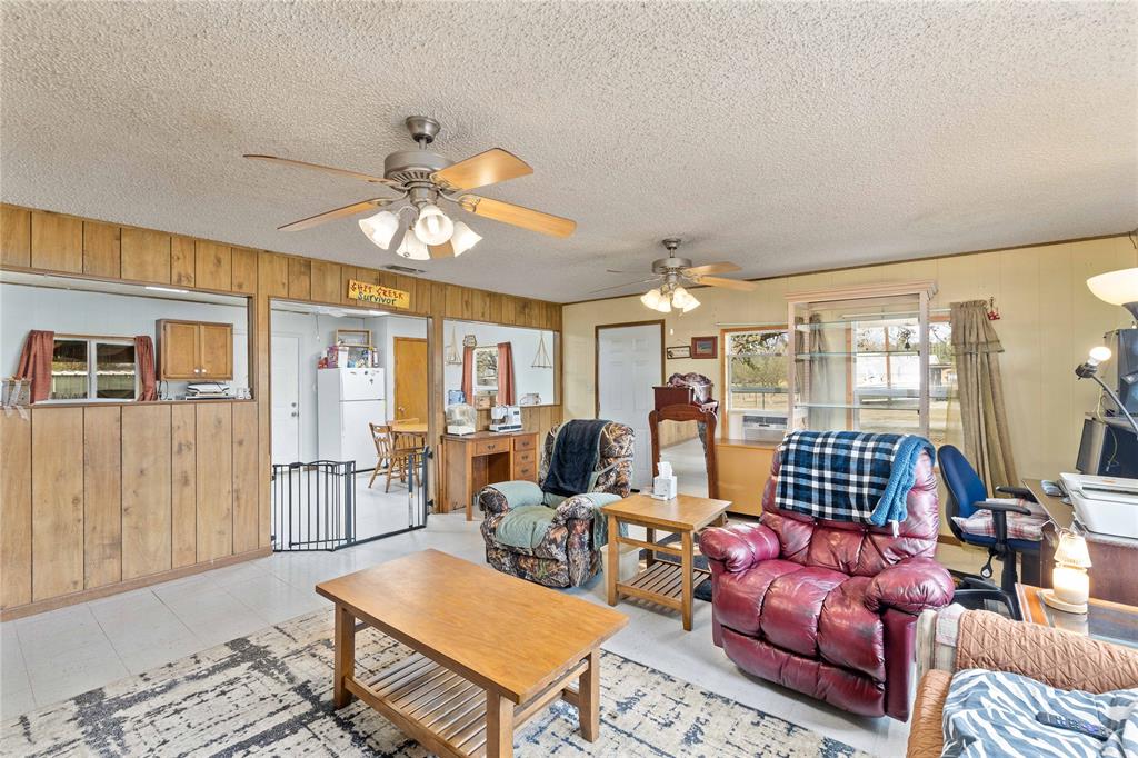 309 Goodwin Street Bangs, TX 76823 - Photo 7 of 20 a living room with furniture chandelier and a table