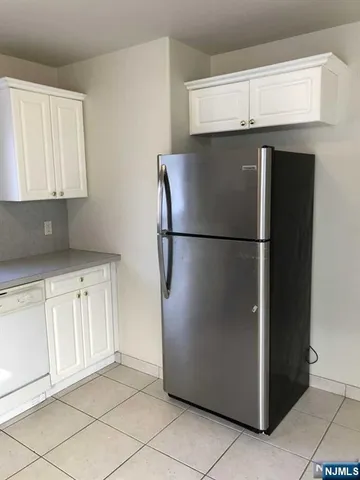 a view of a kitchen with a refrigerator