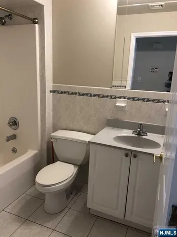 a bathroom with a toilet a sink and bathtub