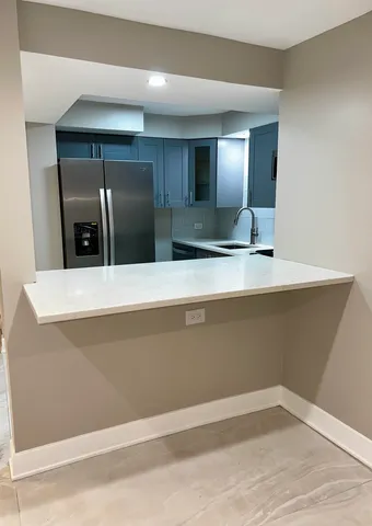 a view of a refrigerator in a kitchen