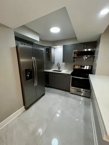 a kitchen with stainless steel appliances a refrigerator and a stove