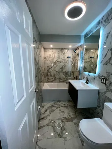 a bathroom with a sink a toilet and tub