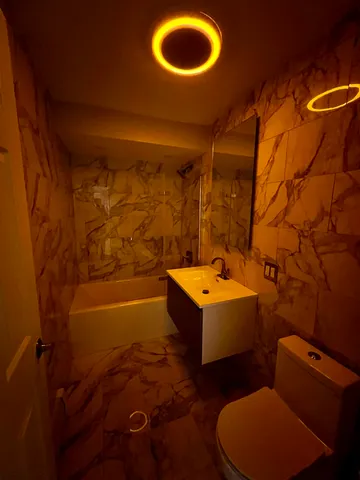 a bathroom with a tub toilet and sink