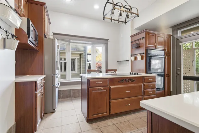 a kitchen with a sink stove and refrigerator