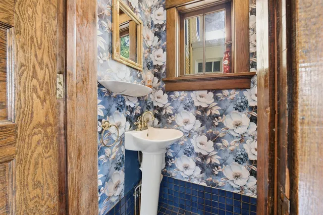 a bathroom with a sink and mirror with toilet