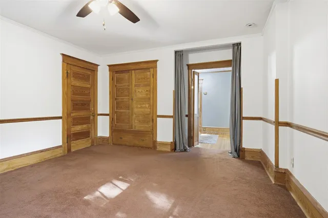 a view of empty room with ceiling fan