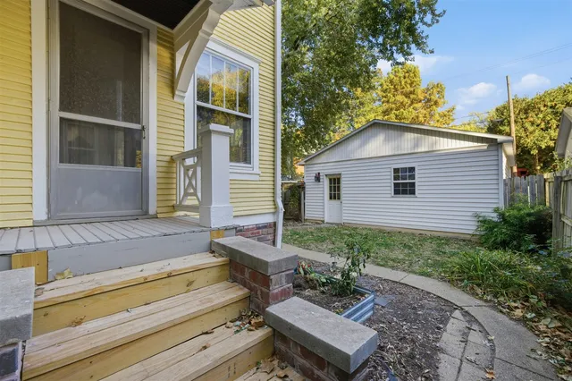 a view of backyard with a patio