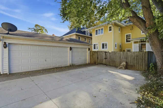 a view of a house with a garage and a yard
