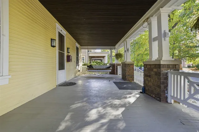 a view of a patio with table and chairs and potted plants