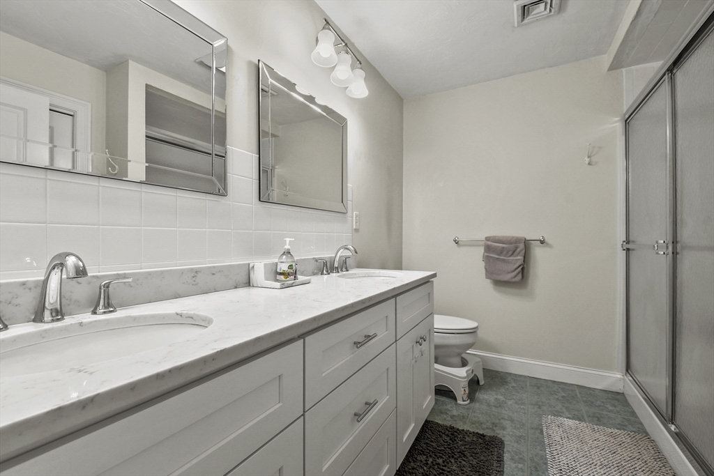 29 Maple Street, Unit C Canton, MA 02021 - Photo 14 of 27 a bathroom with a double vanity sink and mirror