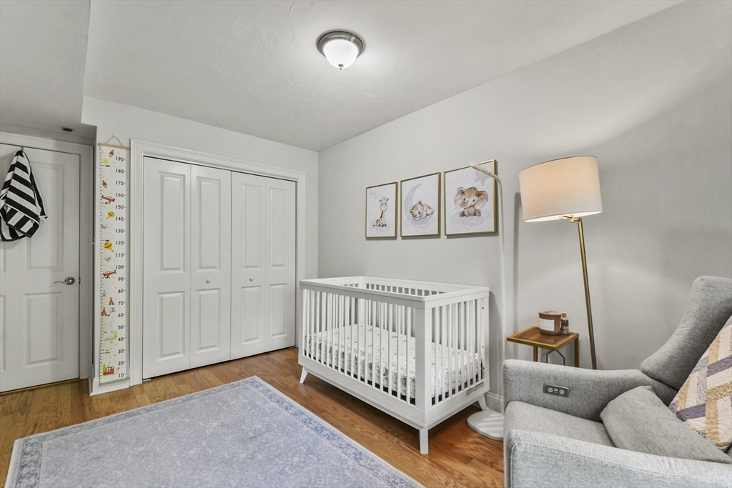 29 Maple Street, Unit C Canton, MA 02021 - Photo 20 of 27 a bedroom with furniture and wooden floor
