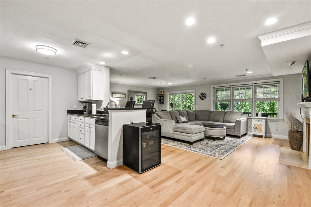 29 Maple Street, Unit C Canton, MA 02021 - Photo 21 of 27 a living room with furniture windows and a kitchen view
