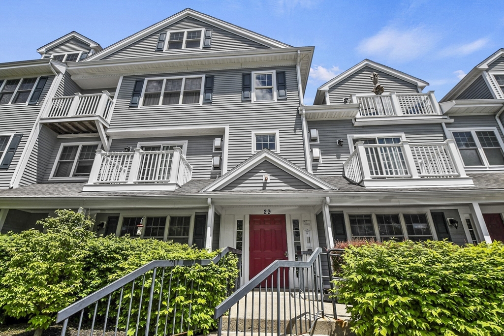 29 Maple Street, Unit C Canton, MA 02021 - Photo 24 of 27 a front view of a house with a yard