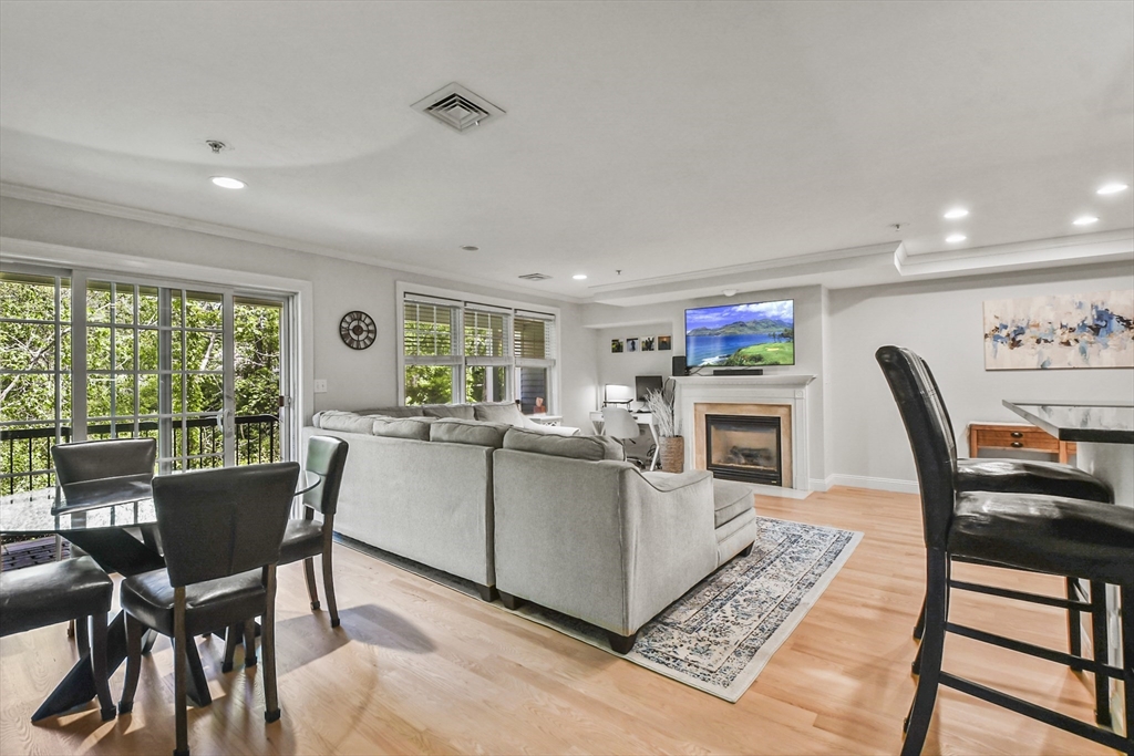 29 Maple Street, Unit C Canton, MA 02021 - Photo 4 of 27 a living room with furniture a fireplace and a large window