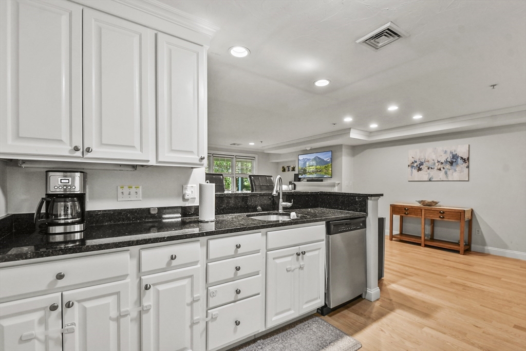 29 Maple Street, Unit C Canton, MA 02021 - Photo 6 of 27 a kitchen with stainless steel appliances granite countertop a sink and cabinets