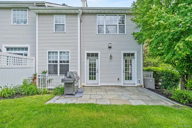 a front view of a house with a garden and yard