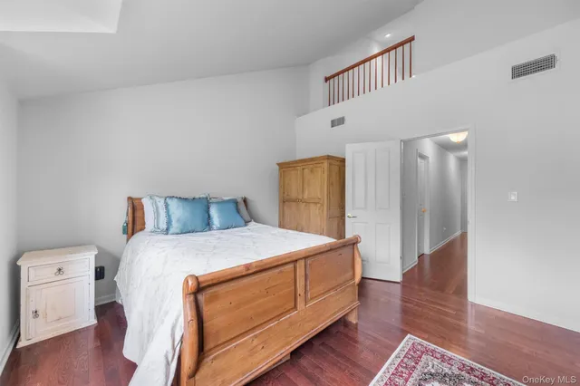 a spacious bedroom with a bed and a table in it