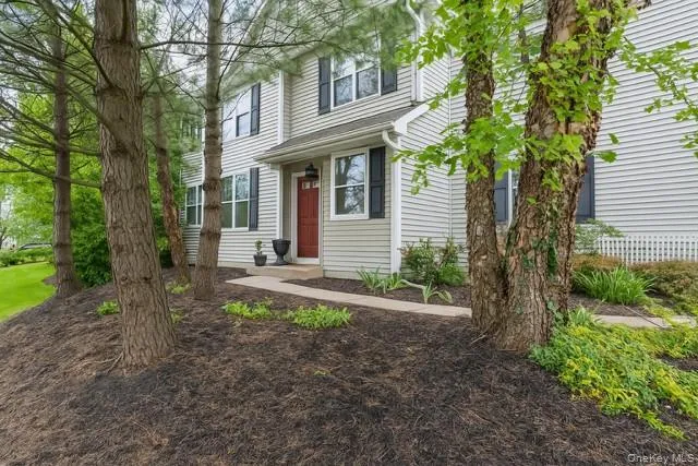 a front view of a house with garden