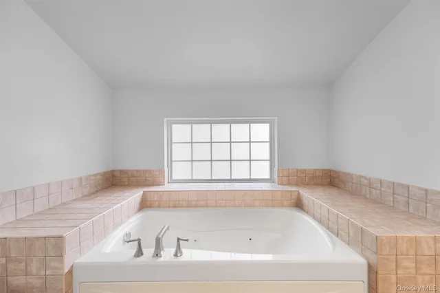 a bath tub sitting in a bathroom next to a window