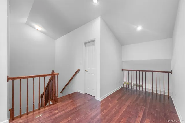 a view of hallway with wooden floor