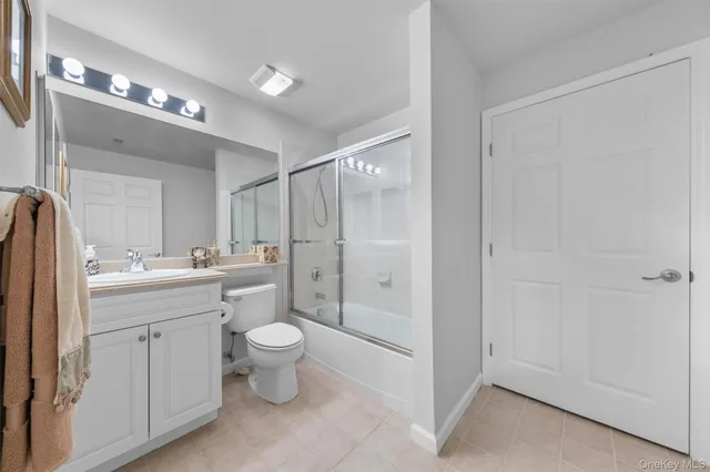 a bathroom with a toilet sink and a mirror