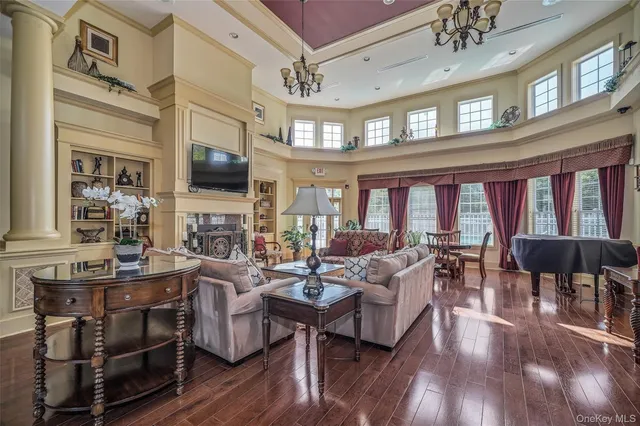 a living room with fireplace furniture and a flat screen tv