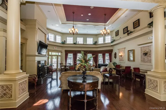 a view of a dining room with furniture a chandelier and wooden floor
