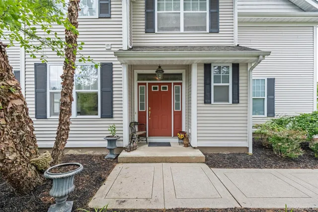 a view of a house with a door and a fire pit