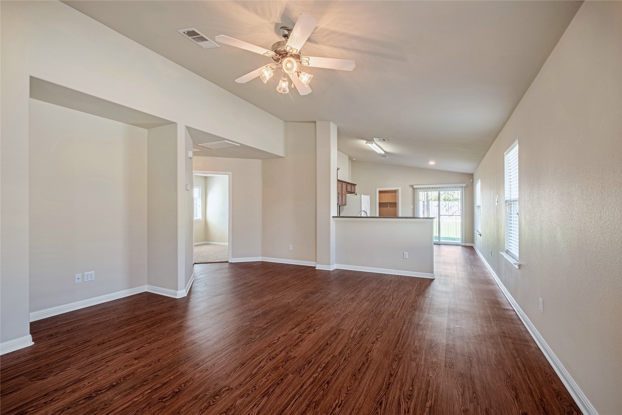 320 Comal Run Hutto, TX 78634 - Photo 6 of 21 a view of a big room with wooden floor and a ceiling fan