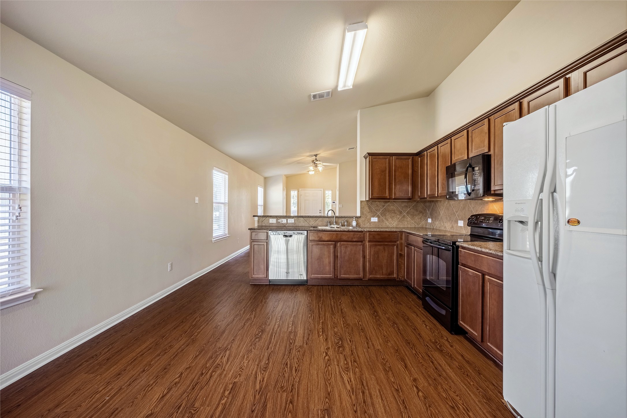320 Comal Run Hutto, TX 78634 - Photo 8 of 21 a kitchen with stainless steel appliances a sink cabinets and wooden floor