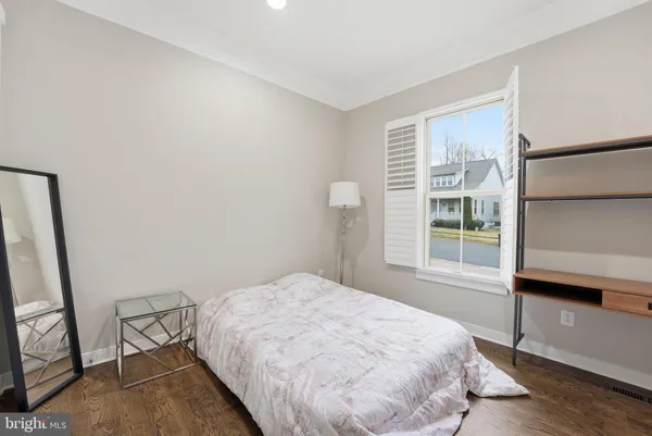 a bedroom with a bed and a flat tv screen on the dresser