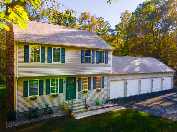 a front view of a house with a yard and outdoor seating