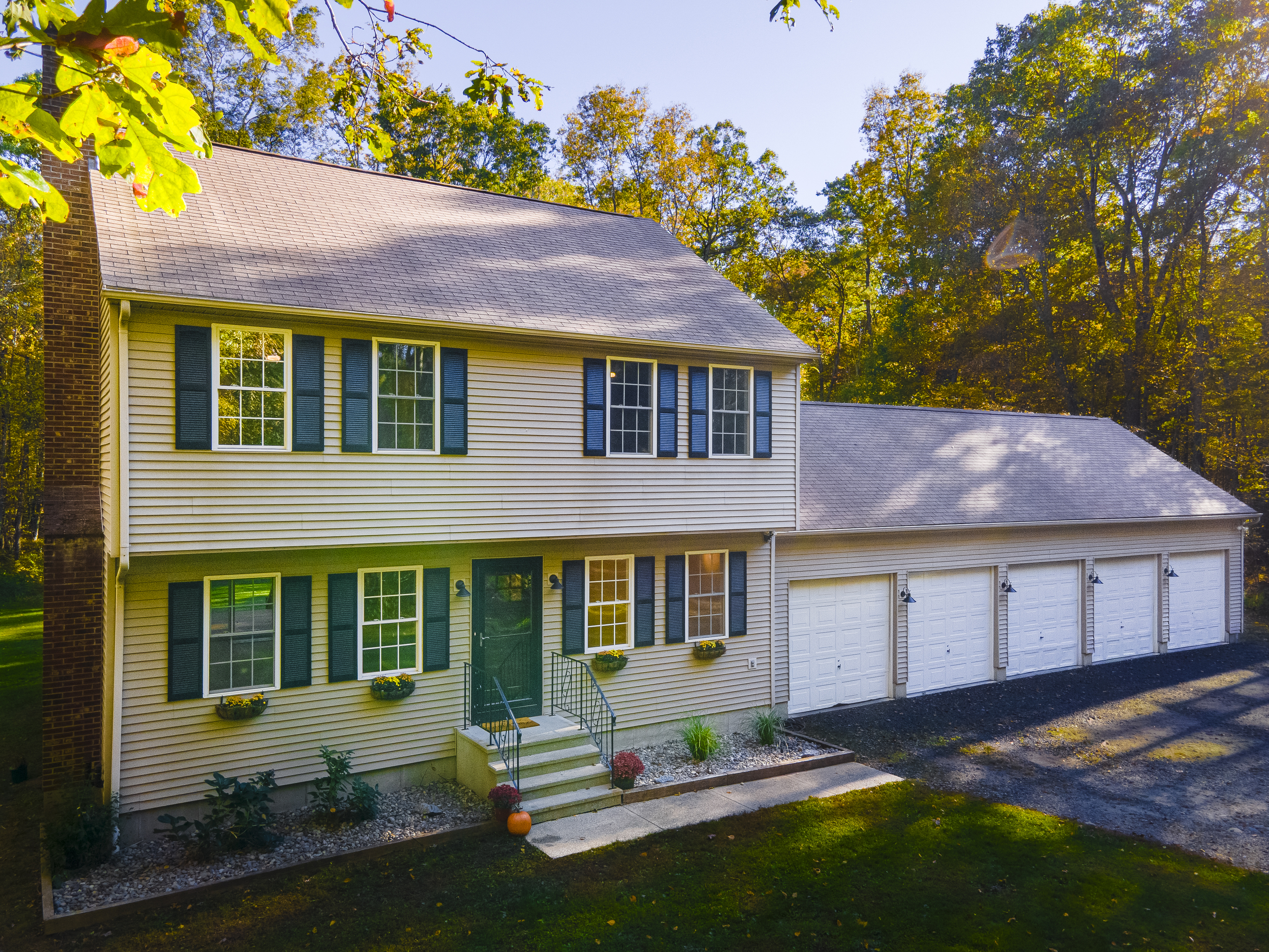 a front view of a house with a yard and outdoor seating