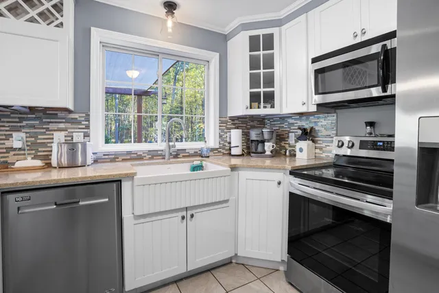 a kitchen with a sink stove and microwave