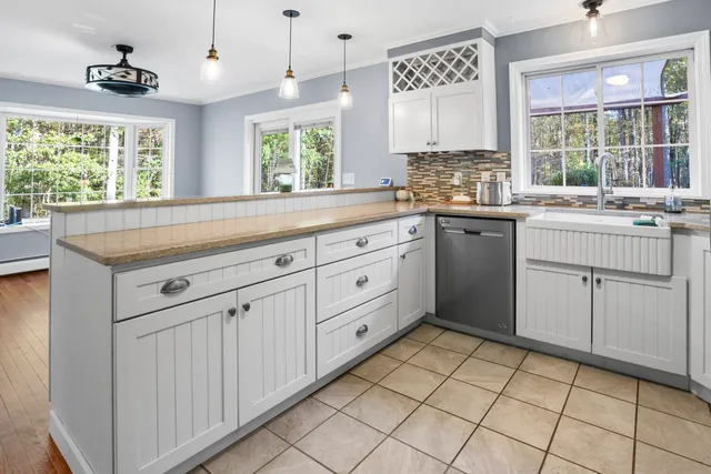 a kitchen with a sink window and cabinets