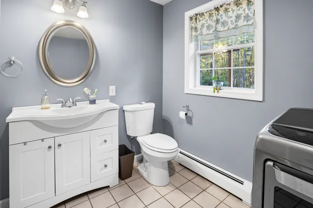 a bathroom with a sink a toilet and a mirror