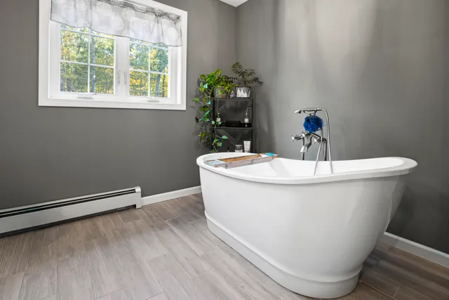 a white bath tub sitting next to a white sink