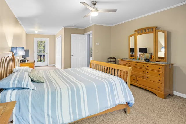 a bedroom with a bed and dresser with mirror